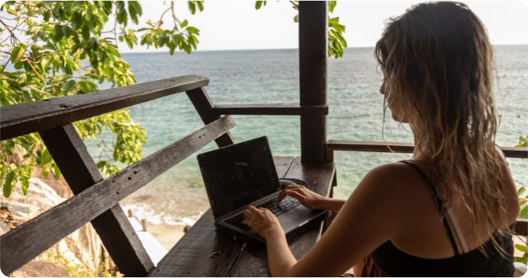 Women working on laptop on the beach 