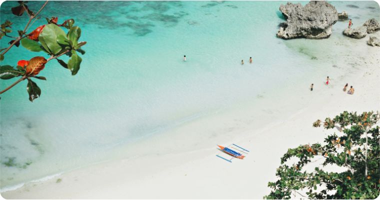 People on the white sand beaches of Boracay in the Philippines 
