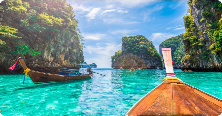 Boat on crystal clear water in Phi Phi Islands Thailand