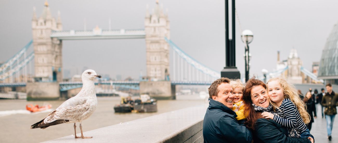 Family and seagull in front of Tower Bridge