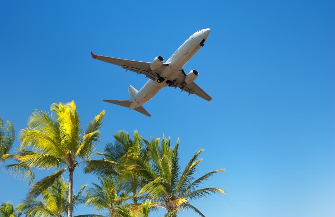 plane-flying-over-tropical-island